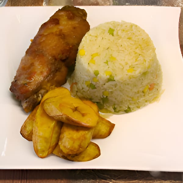 Queen Vees African Cuisine meal with chicken, rice with vegetables, and fried plantains on a white plate.